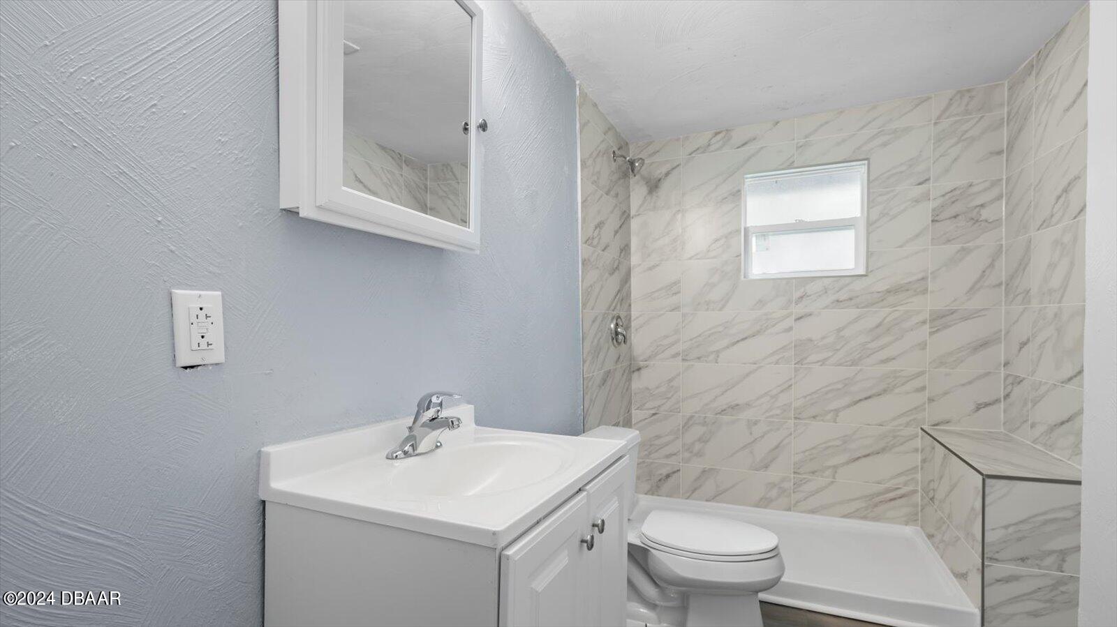 269 Selden Avenue Ormond Beach, FL 32174 - Photo 21 of 41 a bathroom with a sink a toilet and a mirror