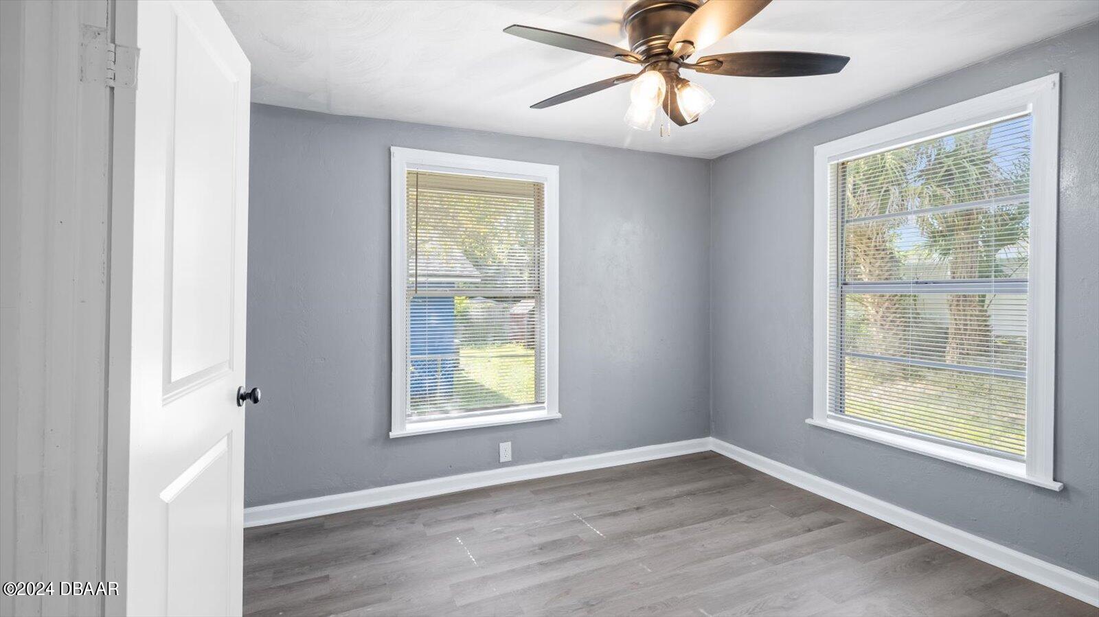 269 Selden Avenue Ormond Beach, FL 32174 - Photo 27 of 41 a view of an empty room with a window and wooden floor