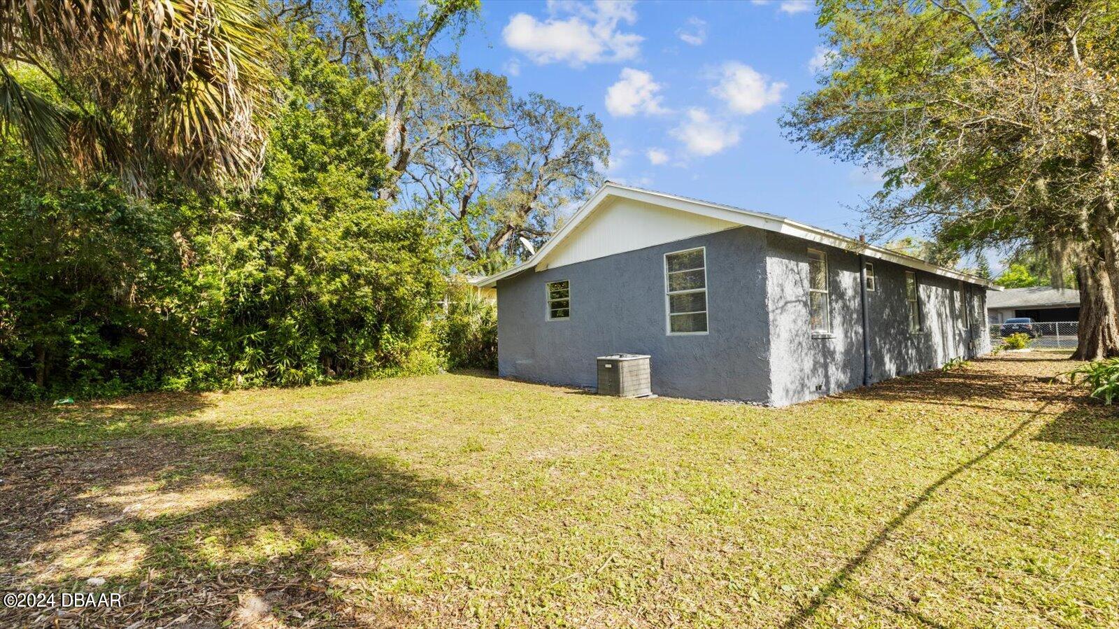 269 Selden Avenue Ormond Beach, FL 32174 - Photo 32 of 41 a large house with a large tree in front of it