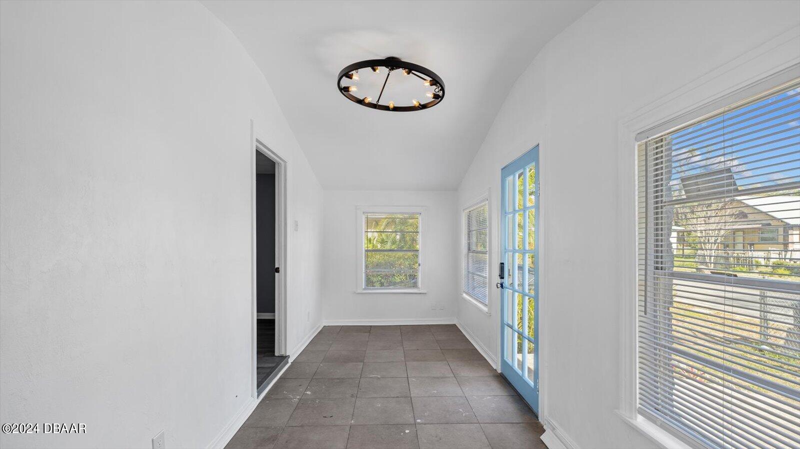 269 Selden Avenue Ormond Beach, FL 32174 - Photo 5 of 41 a view of a hallway with windows and chandelier