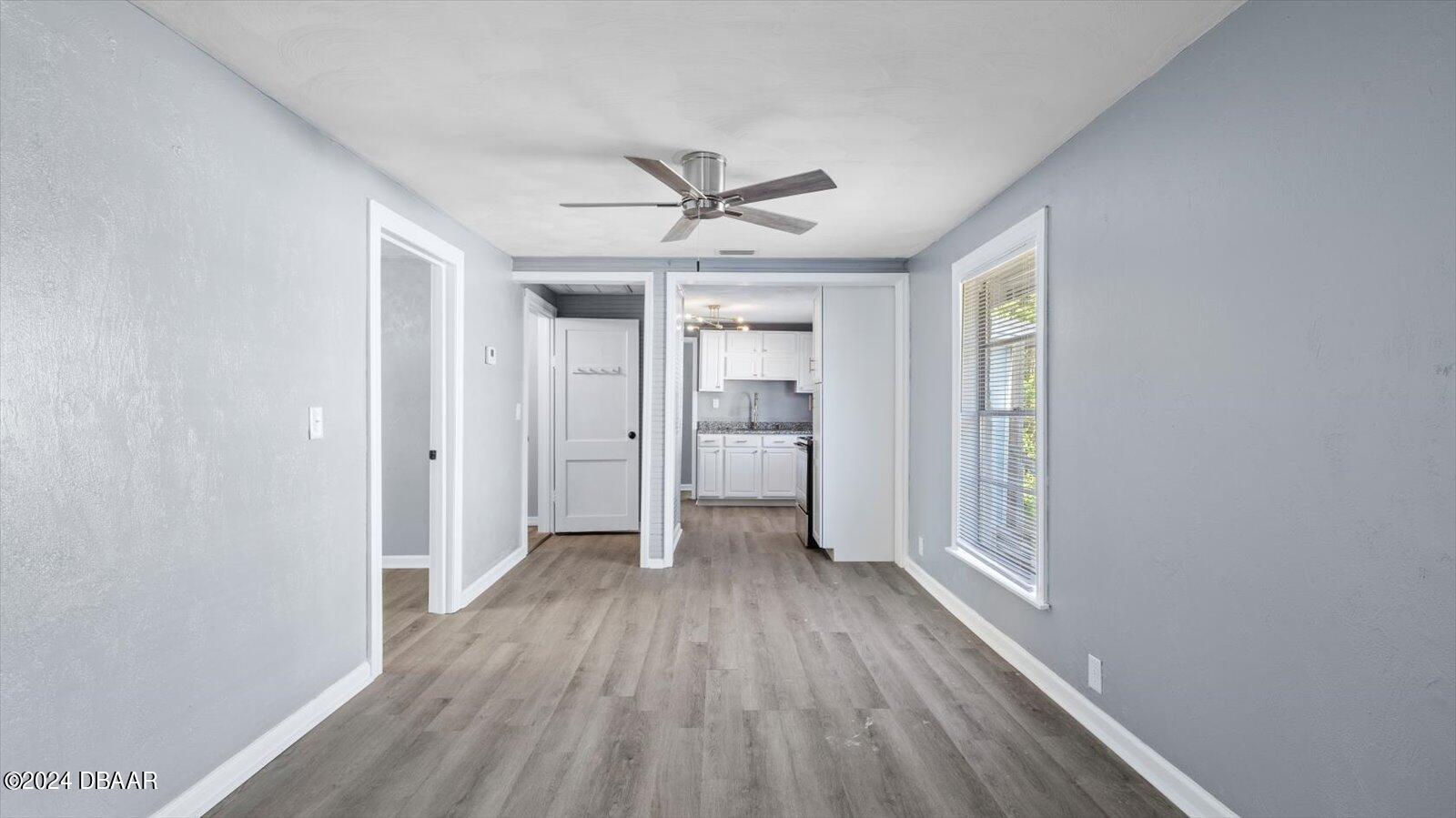 269 Selden Avenue Ormond Beach, FL 32174 - Photo 6 of 41 wooden floor in an empty room with a window
