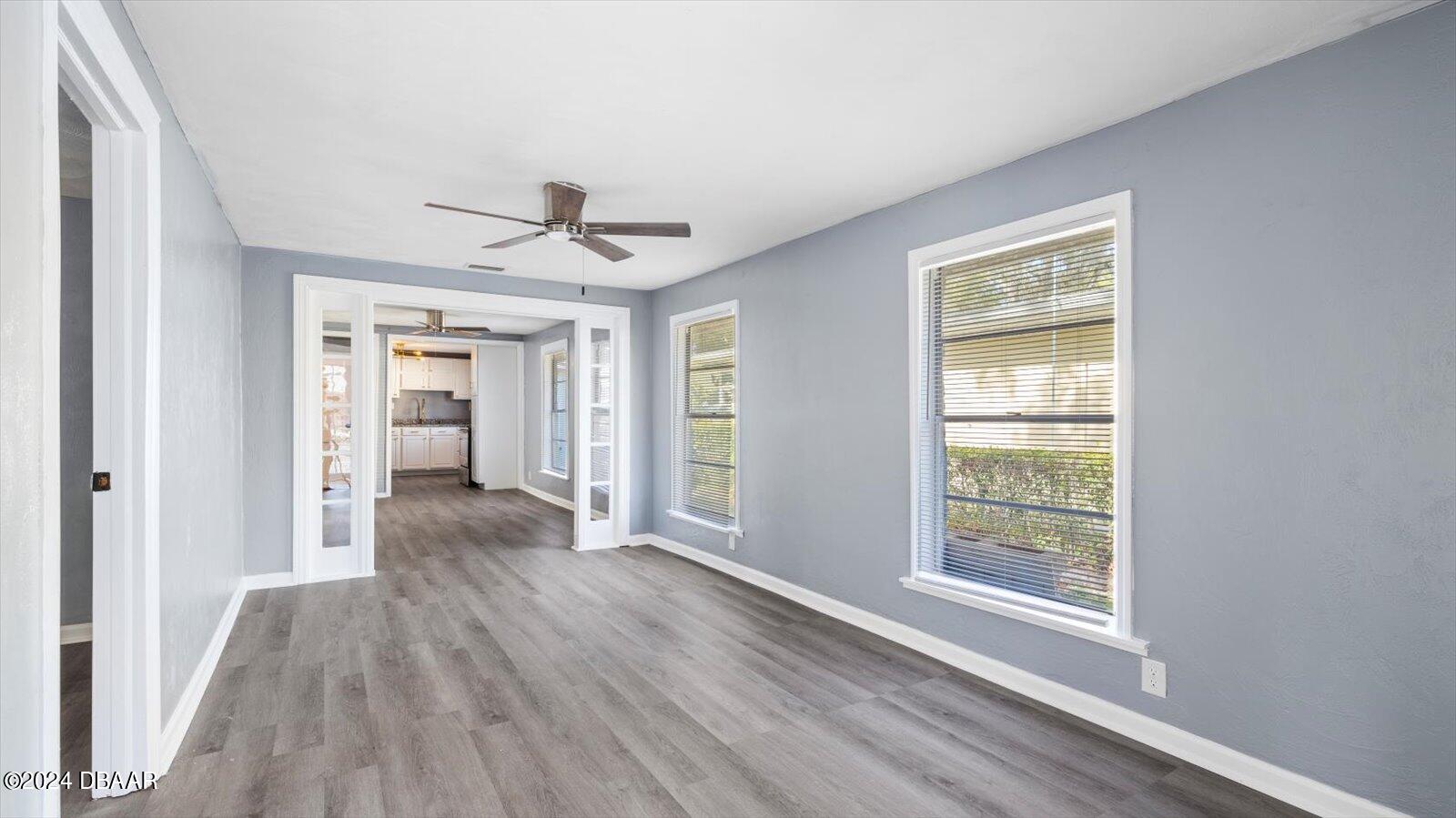 269 Selden Avenue Ormond Beach, FL 32174 - Photo 7 of 41 a view of an empty room with wooden floor and a window