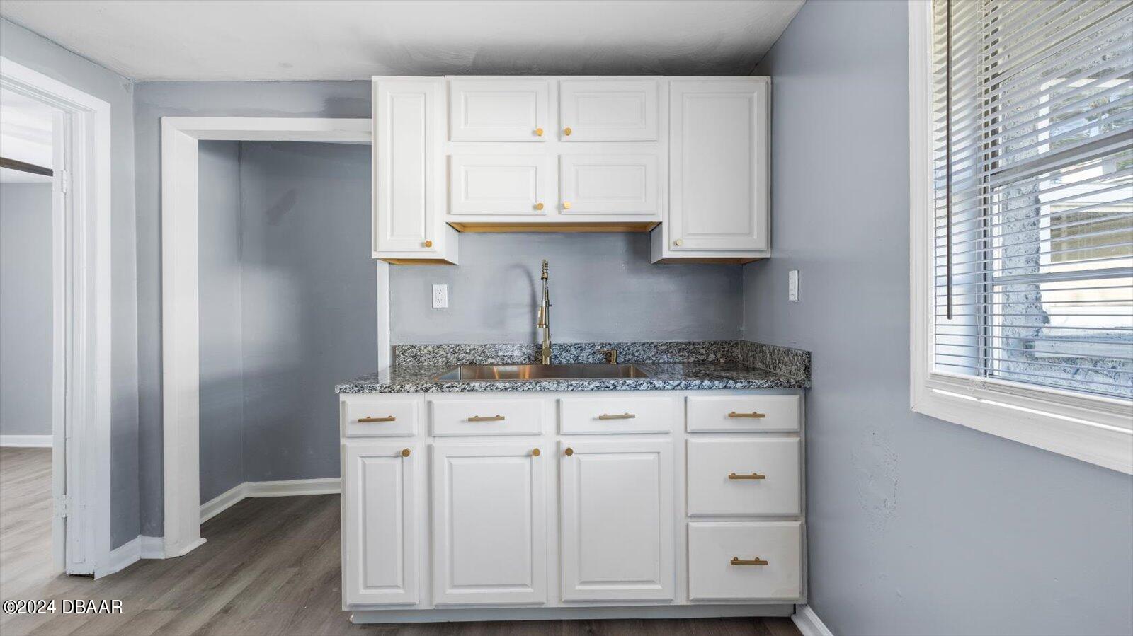 269 Selden Avenue Ormond Beach, FL 32174 - Photo 9 of 41 a kitchen with granite countertop white cabinets and a stove