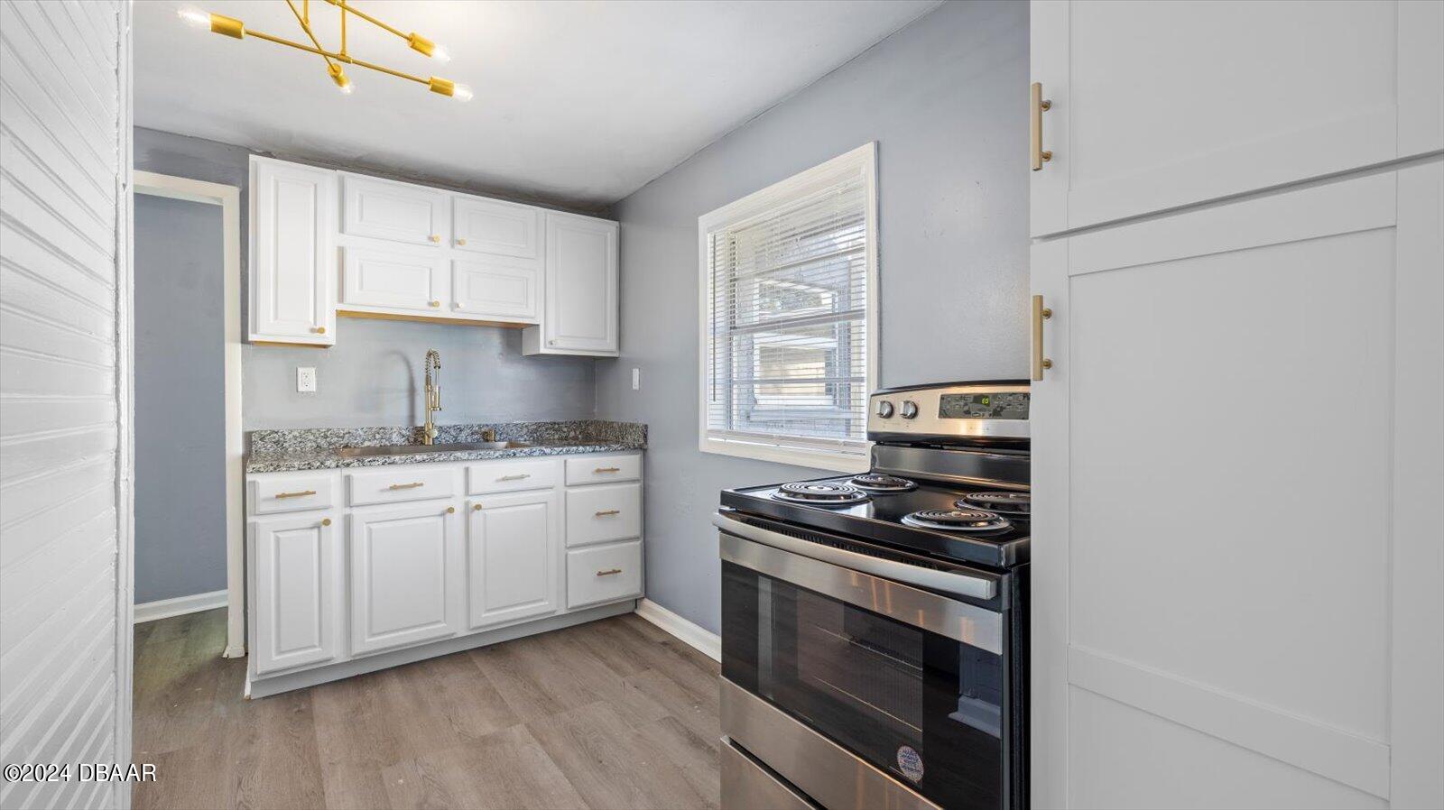 269 Selden Avenue Ormond Beach, FL 32174 - Photo 10 of 41 a kitchen with granite countertop cabinets and steel stainless steel appliances