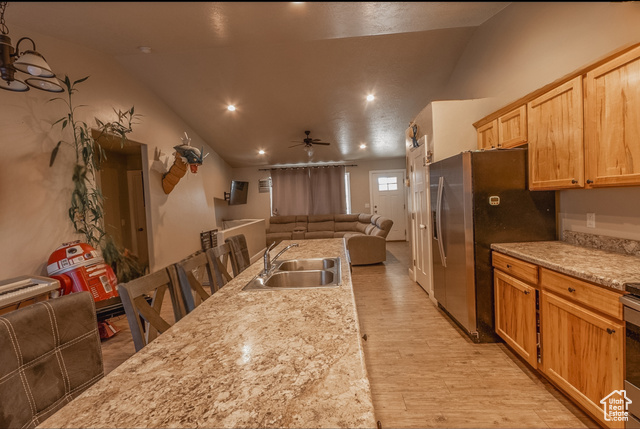 660 East 400 North Spring City, UT 84662 - Photo 15 of 16 Kitchen featuring a sink, stainless steel fridge, open floor plan, light wood-style floors, and ceiling fan