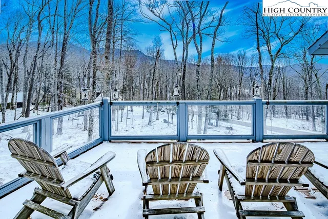 a balcony with table and chairs