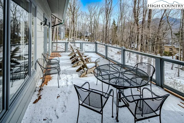 a view of a chairs and table in the balcony