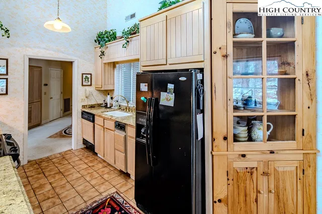 a kitchen with a refrigerator and cabinets