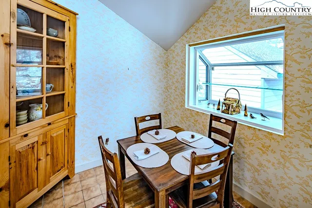 a view of a dining room that has a table and a chair