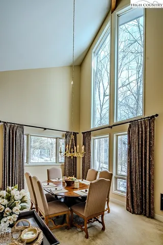 a living room with furniture and floor to ceiling window