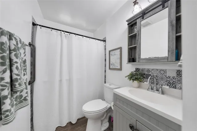 a bathroom with a sink toilet and shower