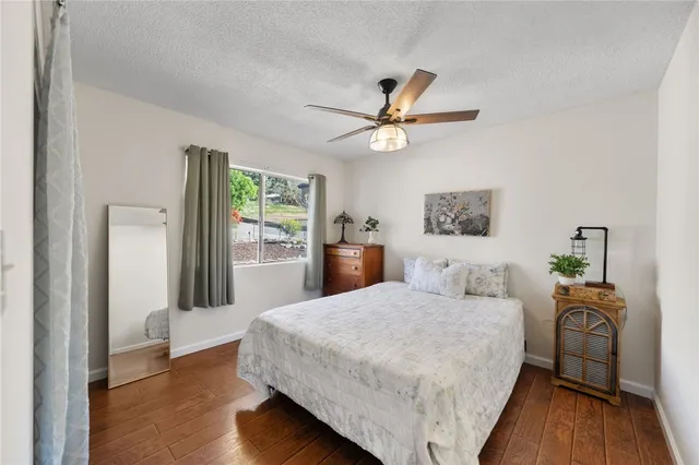 a bedroom with a bed chandelier and a window