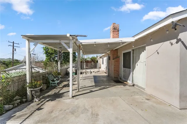 a view of a patio with couches and table and chairs and potted plants