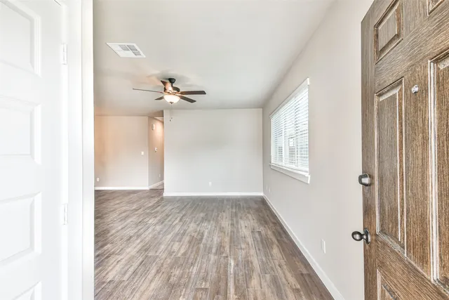 a view of a livingroom with a ceiling fan and window