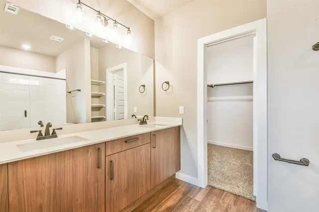 a bathroom with a double vanity sink mirror and