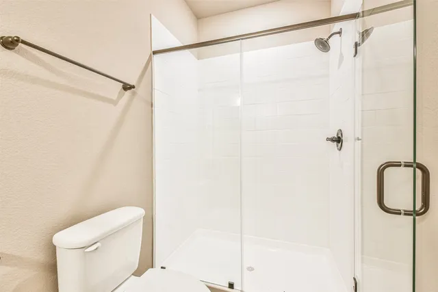 a bathroom with a shower and a toilet