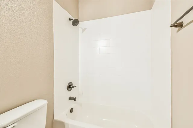 a bathroom with a bathtub and shower