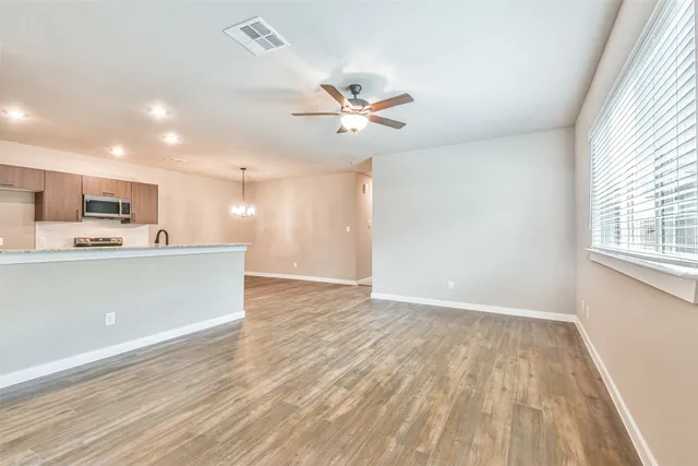 a view of kitchen with wooden floor and electronic appliances