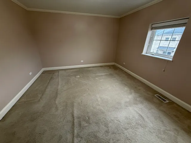 a view of a room with rack on the wall and a window