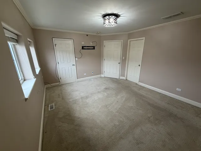 an empty room with a mirror and a sink