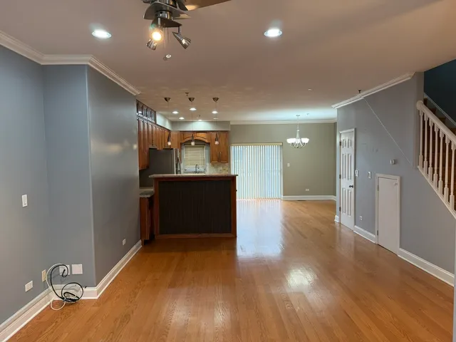 a kitchen with stainless steel appliances kitchen island granite countertop a refrigerator and a sink