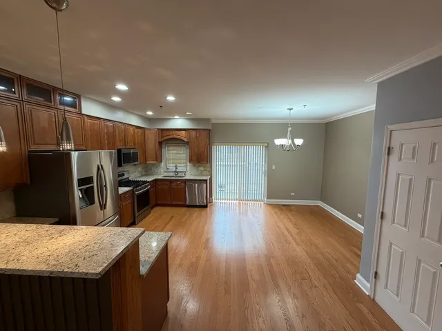 a kitchen with stainless steel appliances granite countertop a refrigerator and a sink