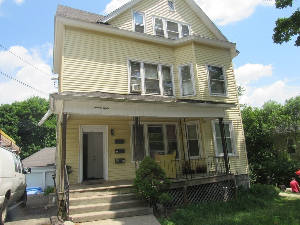 a front view of a house with a garden