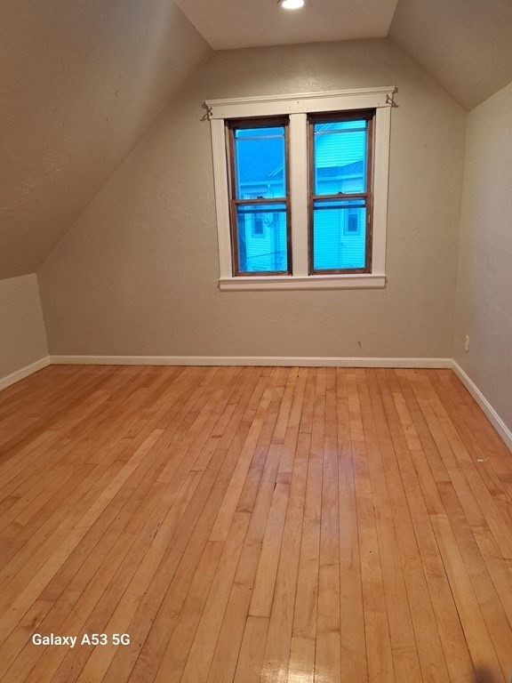 98 Brookline Street, Unit 1 Worcester, MA 01603 - Photo 17 of 18 an empty room with wooden floor and windows