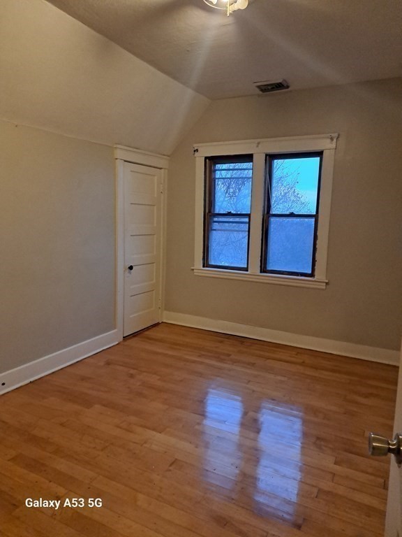 98 Brookline Street, Unit 1 Worcester, MA 01603 - Photo 6 of 18 a view of an empty room with wooden floor and windows