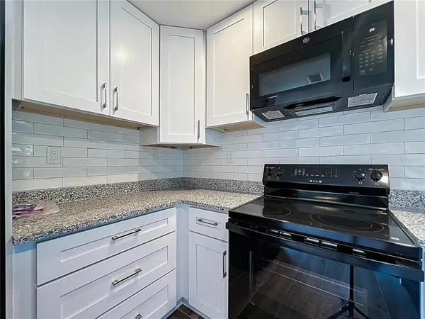 a kitchen with a sink and a refrigerator