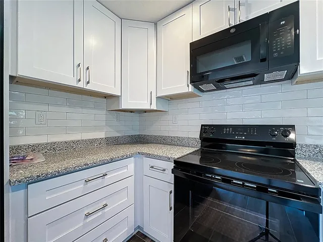 a kitchen with a sink and a refrigerator