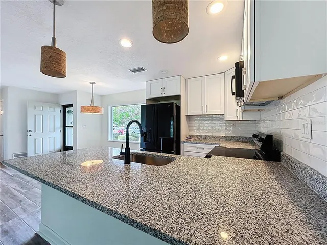 a view of a kitchen with a sink cabinets and a refrigerator