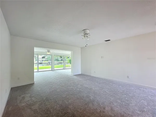 a view of a room with window and a ceiling fan