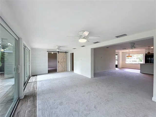 a view of a room with window and a ceiling fan