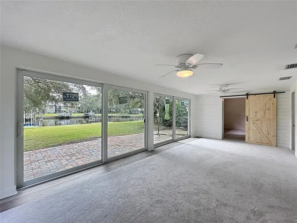 an empty room with closet and fan