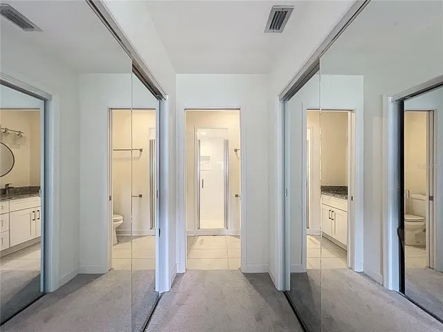 an empty room with a ceiling fan and a window