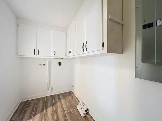 a view of a swimming pool with lawn chairs under an umbrella