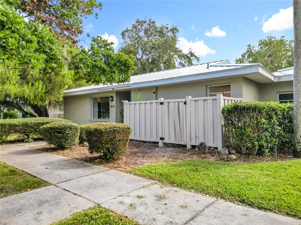 a kitchen with stainless steel appliances kitchen island wooden floors and view living room