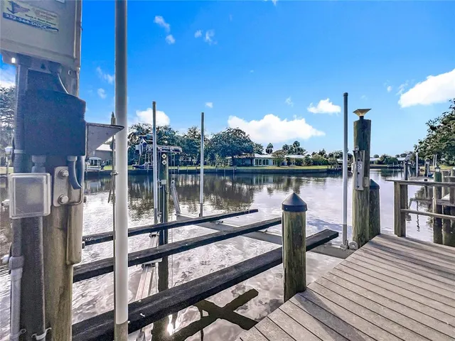 an aerial view of residential houses with outdoor space and lake view