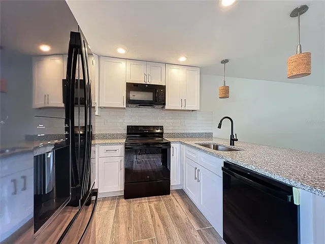 a kitchen with stainless steel appliances a stove a microwave and cabinets