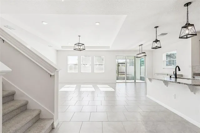 a kitchen with stainless steel appliances granite countertop a sink refrigerator and cabinets