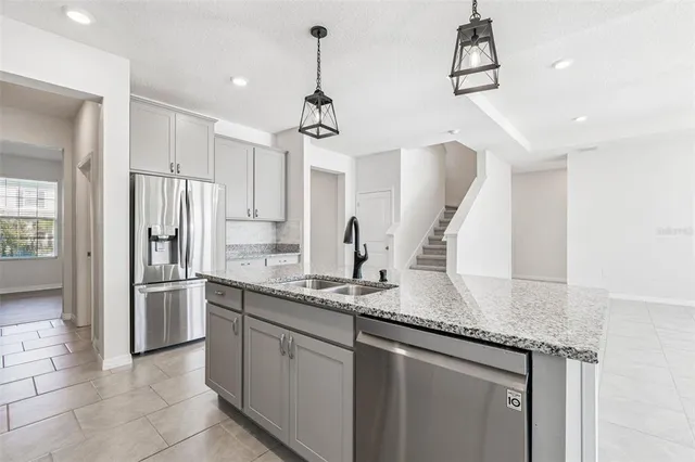 a kitchen with stainless steel appliances granite countertop a sink stove and cabinets