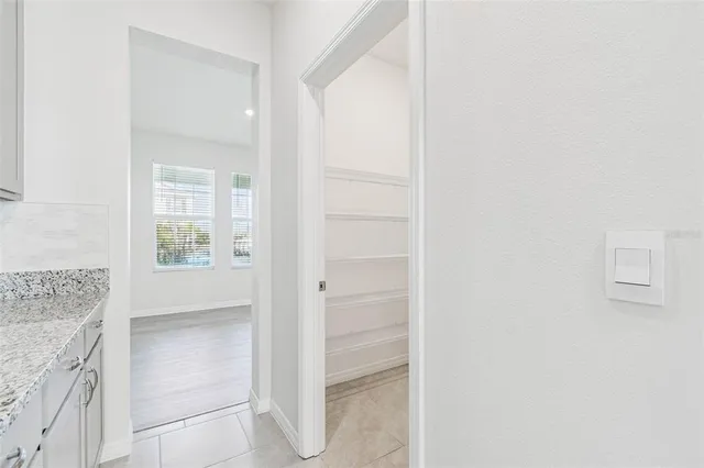 a view of a room with wooden floor and a window
