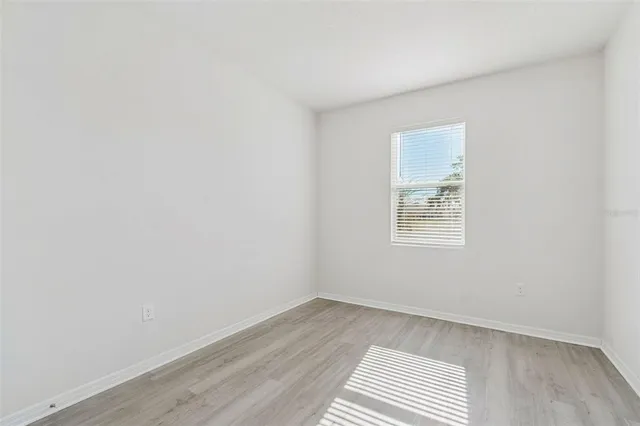 a bathroom with a granite countertop sink a mirror and a shower