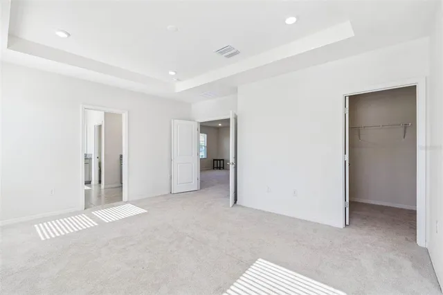 a bedroom with a bed potted plant and a large window