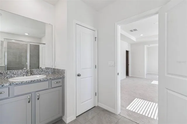 a bedroom with two beds and potted plant