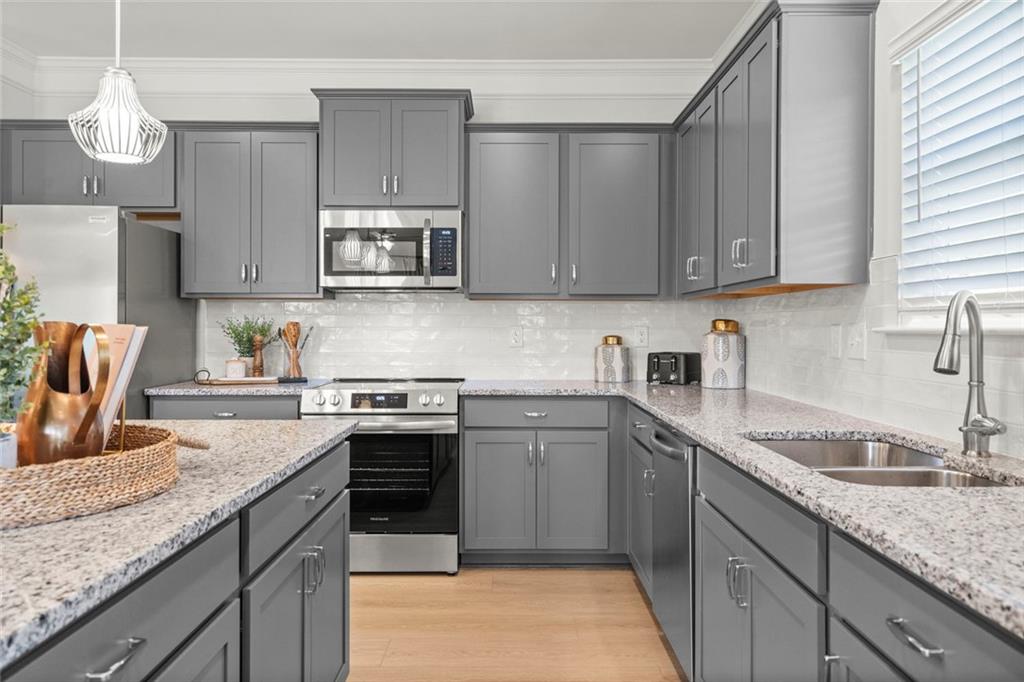 16 Willow Circle Rock Spring, GA 30739 - Photo 12 of 30 a kitchen with granite countertop stainless steel appliances sink microwave and stove