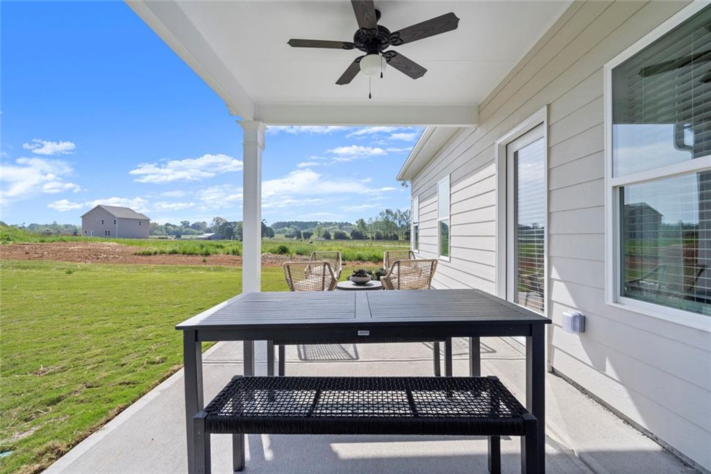 16 Willow Circle Rock Spring, GA 30739 - Photo 29 of 30 a view of a patio with table and chairs under an umbrella with large trees
