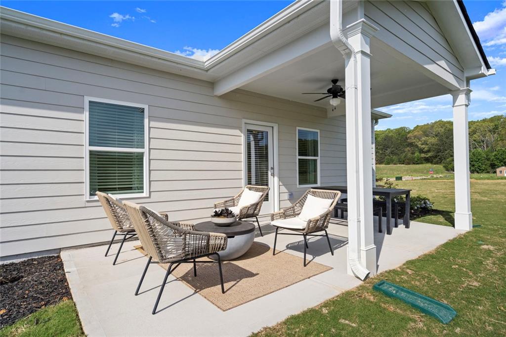 16 Willow Circle Rock Spring, GA 30739 - Photo 30 of 30 a view of a patio with table and chairs and floor to ceiling window