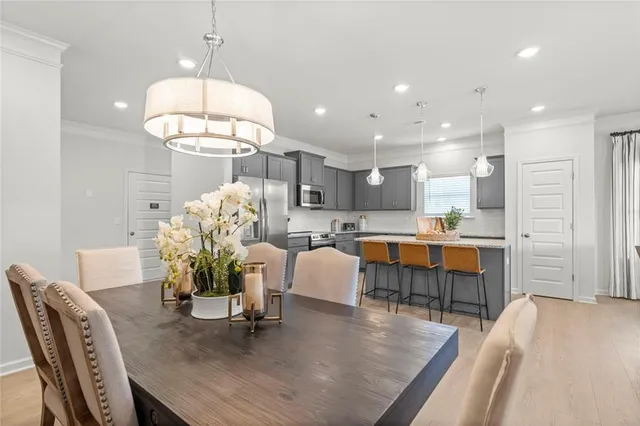 a large living room with stainless steel appliances kitchen island granite countertop furniture and a dining table